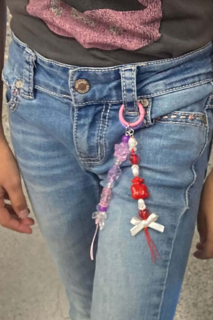 Kawaii purple and kawaii red and white beaded elements combined onto a snap ring for a cool belt loop accessory. 